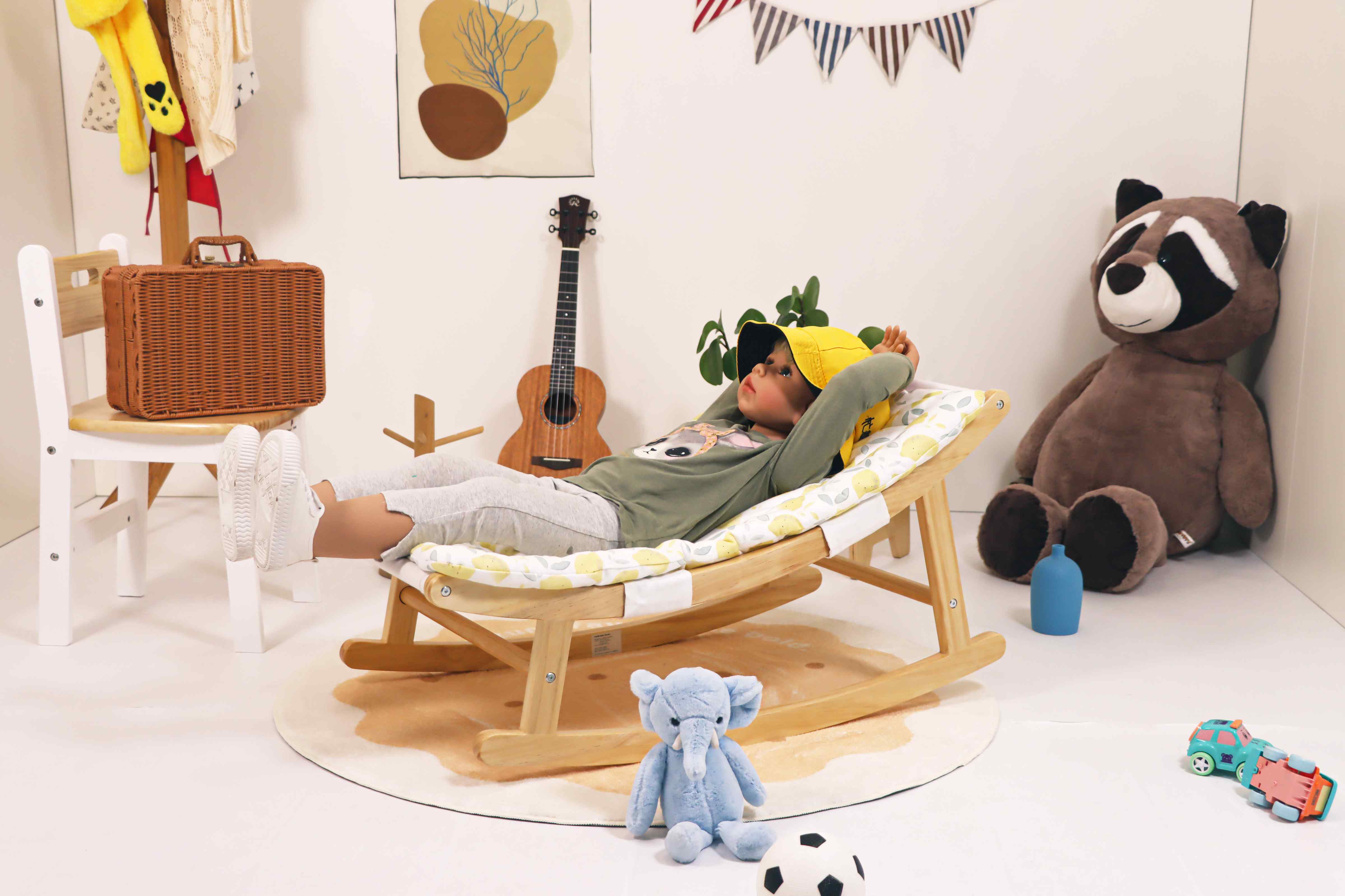 Gentle floor baby lounger with 15° ergonomic tilt. Breathable cotton cover, sturdy pine frame. 100lb capacity. Ages 3M+.